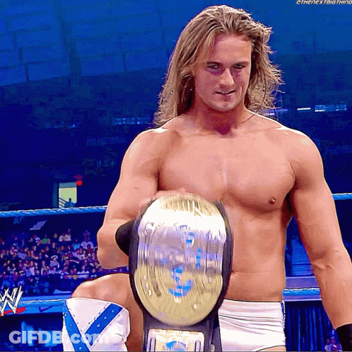Shirtless Wrestler Holding World Heavyweight Championship GIF
