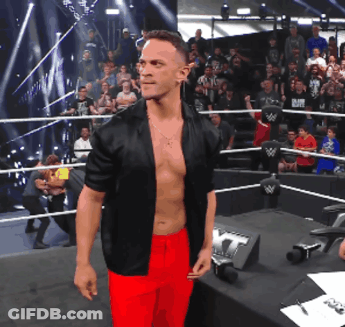 Shirtless Wrestler In Black Jacket And Red Pants GIF