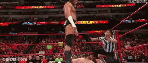 Shirtless Wrestler In Front Of Big Cass Sign GIF