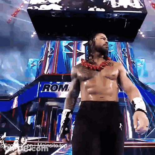 Shirtless Wrestler In Front Of Building Saying Rom GIF