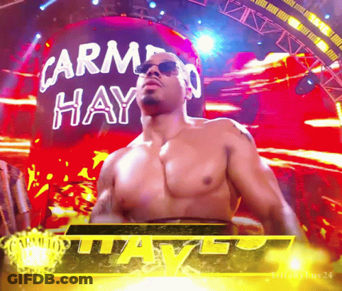 Shirtless Wrestler In Front Of Carmen Hay Sign GIF
