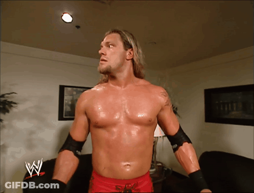 Shirtless Wrestler In Front Of Couch With W GIF