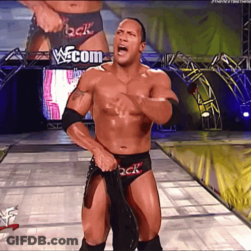 Shirtless Wrestler In Front Of W.com Sign GIF