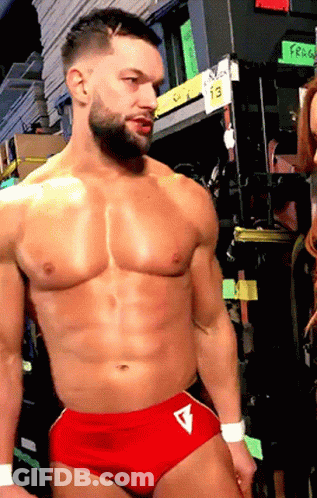 Shirtless Wrestler In Red Shorts With Letter V GIF