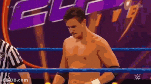 Shirtless Wrestler In Ring With Referee And WWE Logo GIF