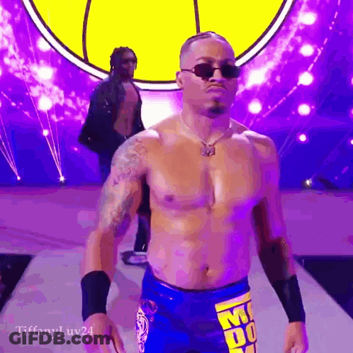 Shirtless Wrestler In Sunglasses Walking Down Purple Ramp GIF