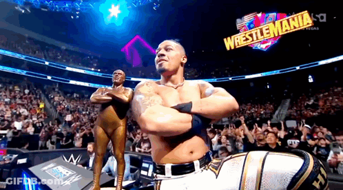 Shirtless Wrestler Smiling In Front Of Crowd GIF