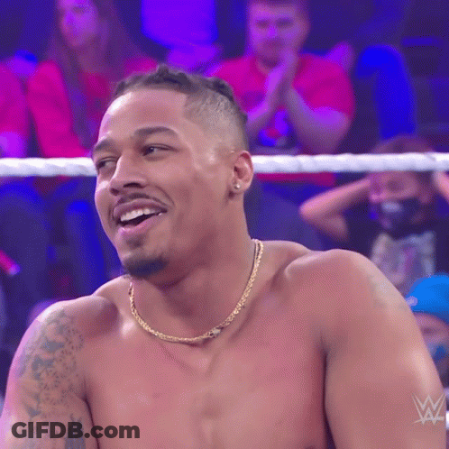 Shirtless Wrestler Smiling In Front Of Crowd GIF