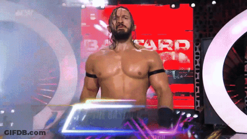 Shirtless Wrestler Standing In Front Of Bard Screen GIF