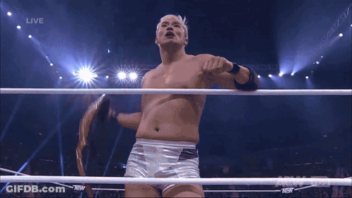 Shirtless Wrestler Standing In Front Of Live Screen GIF