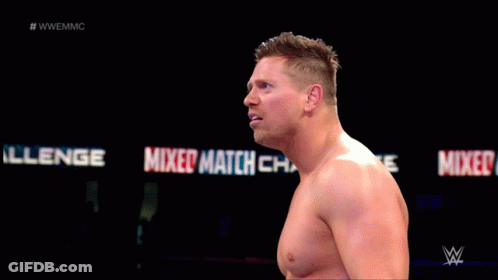 Shirtless Wrestler Standing In Front Of Mixed Match Sign GIF