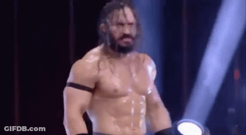 Shirtless Wrestler Standing In Spotlight GIF