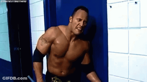 Shirtless Wrestler Standing Next To Blue Door GIF