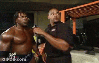 Shirtless Wrestler Talking To Another Man GIF