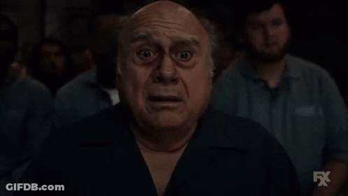 Shocked Man In Front Of Group With FX Logo GIF