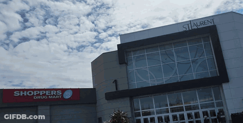 Shoppers Drug Mart In Front Of Large Building GIF