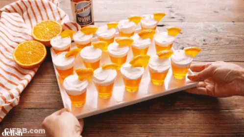 Shot Glasses With Orange Slices And Blue Moon GIF