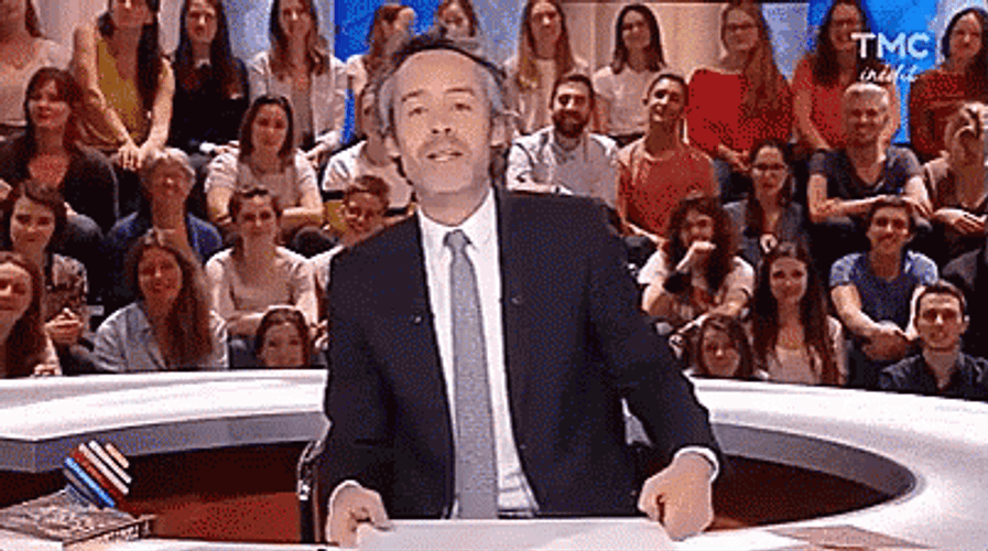 Show Presenter Holding Poop Emoji GIF