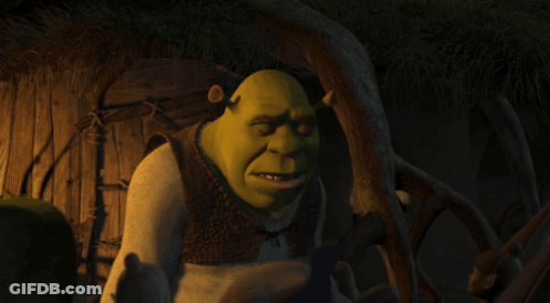 Shrek Covering His Eyes With His Hand And The Word Okay Written Below Him GIF
