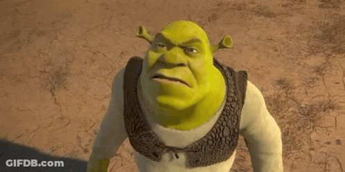 Shrek From The Movie Shrek Is Standing In The Dirt And Looking At The Camera . GIF