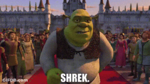 Shrek From The Movie Shrek Is Standing On A Red Carpet In Front Of A Crowd Of People GIF