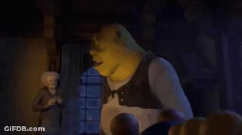 Shrek Is Giving A Thumbs Up To A Man In A Dark Room . GIF