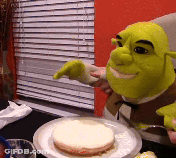 Shrek Is Pointing At A Piece Of Cake On A White Plate GIF