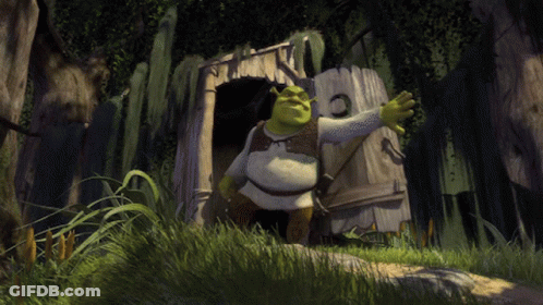Shrek Is Standing In Front Of A Wooden Shack In The Woods GIF