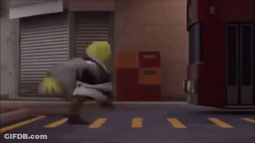 Shrek Is Walking Across A Crosswalk In Front Of A Bus . GIF