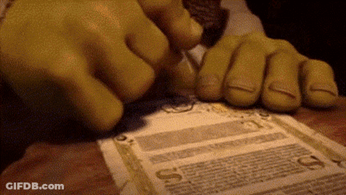 Shrek 'S Hands Are Holding A Piece Of Paper That Says ' A ' On It . GIF
