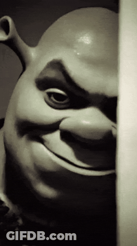Shrek Statue Peeking From Behind Wall Smiling GIF