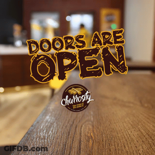 Sign That Says Doors Are Open On Wooden Counter GIF