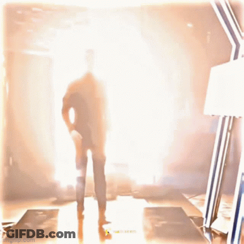 Silhouette Man In Suit Walking Through Tunnel GIF