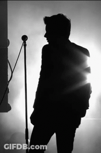 Silhouette Man Singing Into Microphone GIF