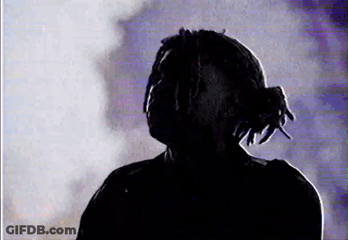 Silhouette Man With Dreadlocks In Dark Room GIF
