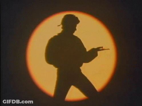 Silhouette Of Man Holding Gun By Circle Of Light GIF