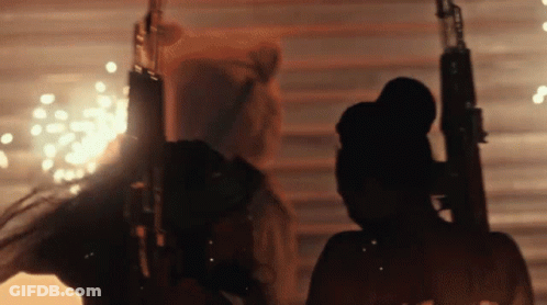 Silhouette Of Man Holding Gun With Fireworks GIF