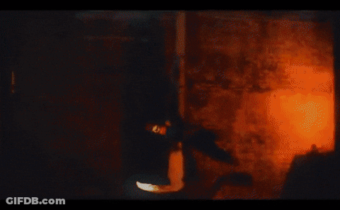 Silhouette Of Man In Front Of Orange And White Painting GIF