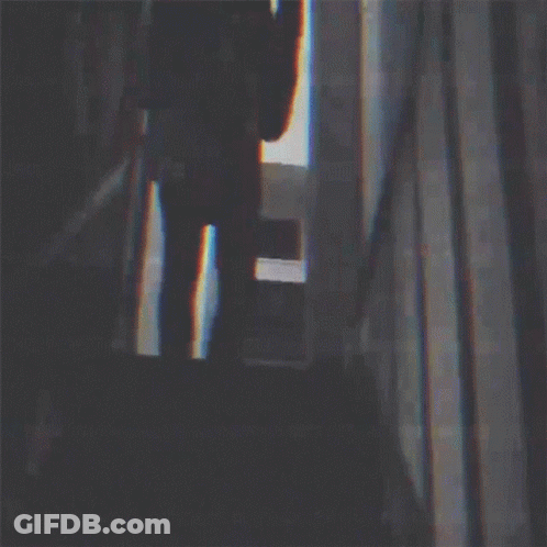 Silhouette Of Man Playing Guitar In Dark Room GIF