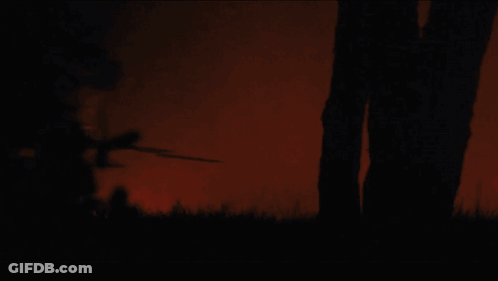 Silhouette Of Man Running With Sword GIF