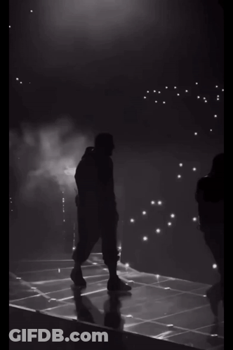 Silhouette Of Man Walking On Stage GIF