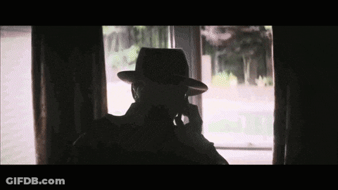 Silhouette Of Man Wearing Hat Talking On Cell Phone GIF