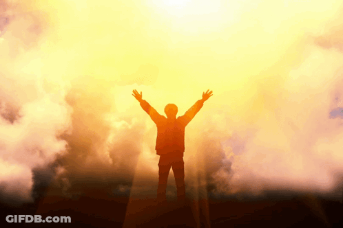 Silhouette Of Man With Arms Outstretched In Front Of Sun GIF
