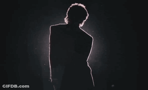 Silhouette Of Person In Dark Room With Red Light GIF