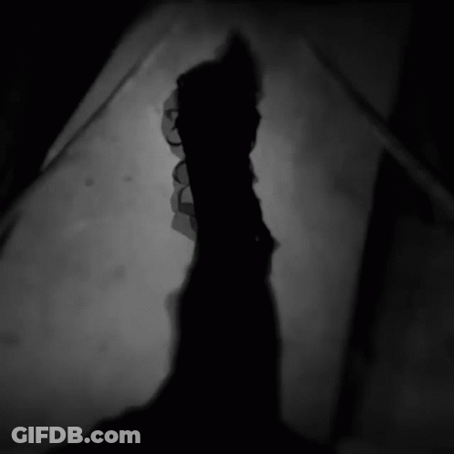 Silhouette Of Person With Glowing Eyes GIF