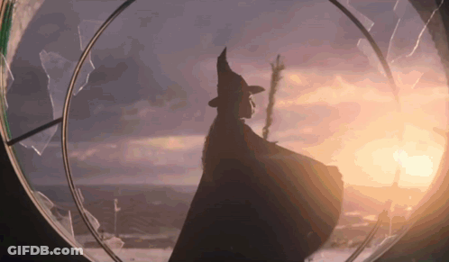 Silhouette Of Woman In Witch Costume At Sunset GIF