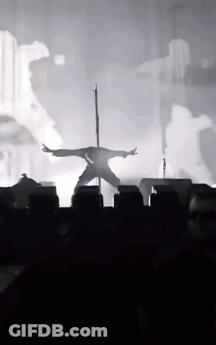 Silhouette Person On Pole Arms Outstretched GIF