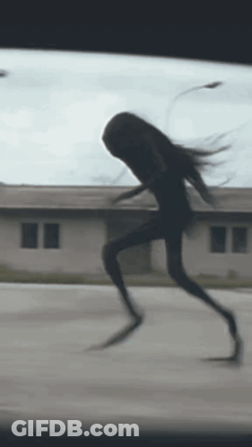 Silhouette Running Down Street GIF