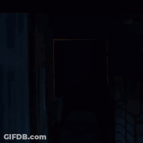 Silhouette Walking Through Dark Hallway GIF