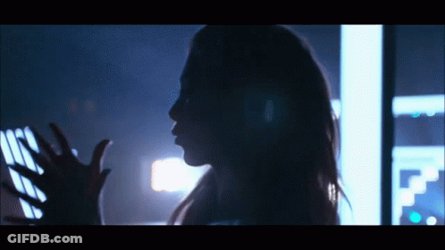 Silhouette Woman Reaching Hand In Dark Room GIF